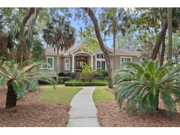 Charming single-Gathering home featuring a well-manicured lawn and welcoming front porch at 2515 Cat Tail Pond Rd, Seabrook Island, SC 29455