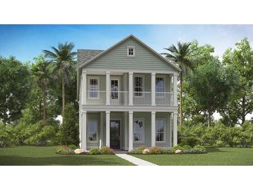 Charming two-story home with a columned porch and manicured lawn at 297 Citrus Dr, Summerville, SC 29486