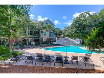 Enjoy this pristine pool with lounge chairs and beautiful landscaping at 300 Bucksley Ln # 104, Charleston, SC 29492