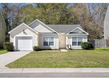 Charming one-story home with manicured lawn, attached garage, and inviting entrance at 5024 Blair Rd, Summerville, SC 29483