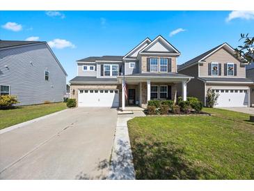 Charming two-story home with a well-manicured lawn and a two-car garage in a desirable neighborhood at 707 Redbud Ln, Summerville, SC 29486