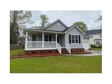 Charming single-Gathering home with a inviting covered front porch and well-manicured lawn at 8309 Berringer Bluff, North Charleston, SC 29418