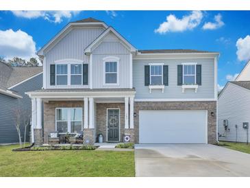 Charming two-story home with a brick and siding exterior, complemented by a well-manicured lawn at 107 Willett Ln, Summerville, SC 29486