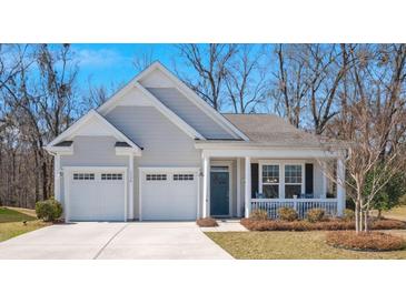 Charming home with a two-car garage, inviting front porch, and manicured landscaping, perfect for suburban living at 1174 Old Field Dr, Summerville, SC 29483