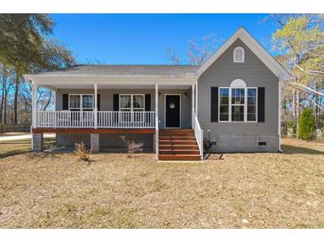 Charming one-story home featuring a welcoming front porch and light-gray siding at 146 Picard Dr, Ladson, SC 29456