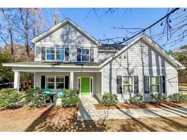 Charming two-story home featuring a welcoming front porch and bright green door at 1926 Grimball Rd, Charleston, SC 29412