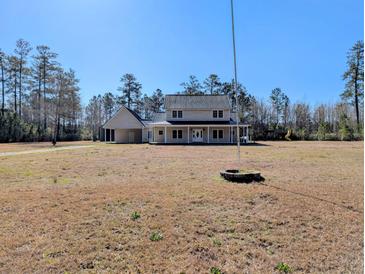 Charming two-story home with a metal roof, front porch, and a spacious yard at 305 Sandridge Rd, Dorchester, SC 29437