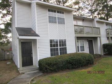 Charming townhouse with a well-maintained lawn and inviting curb appeal at 7851 Sandida Ct, North Charleston, SC 29418