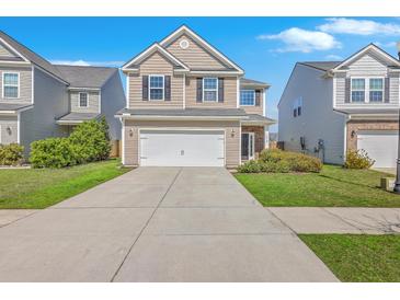 Charming two-story home featuring a two-car garage, manicured lawn, and a welcoming facade at 787 Redbud Ln, Summerville, SC 29486