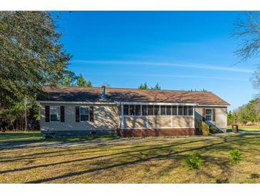 Charming single-story home with a screened-in porch and well-maintained yard at 165 Infinity Dr, Dorchester, SC 29437