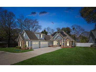 Charming two-story home with stone accents, a three-car garage, and well-maintained landscaping at 1874 Rifle Range Rd, Mount Pleasant, SC 29464