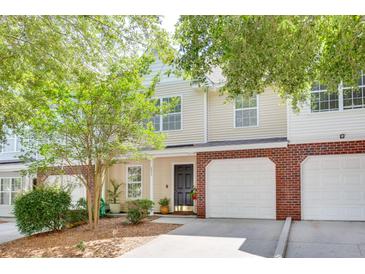 Charming townhome with brick accents, attached garages, and a well-maintained front yard and landscaping at 275 Kelsey Blvd, Charleston, SC 29492