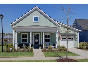 Charming single-Gathering home with a cozy front porch, pristine landscaping, and a two-car garage at 3522 Habenaria Rd, Mount Pleasant, SC 29466