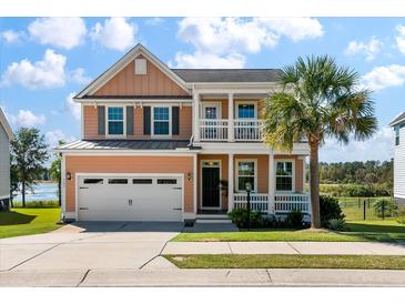 Charming two-story home with a manicured lawn and a welcoming front porch with a palm tree at 543 Pendleton Dr, Moncks Corner, SC 29461