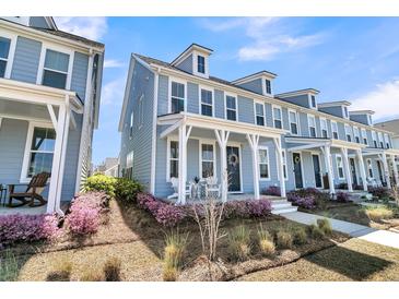 Charming two-story home with a welcoming front porch and beautiful landscaping at 565 Blueway Ave, Summerville, SC 29486