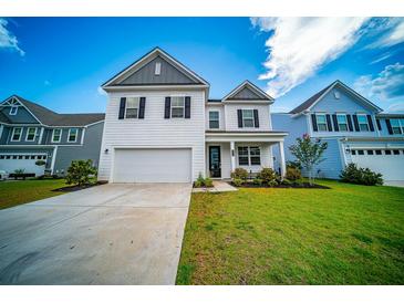 Charming two-story home featuring a well-manicured lawn and a classic white exterior, perfect for suburban living at 107 Goose Rd, Summerville, SC 29483