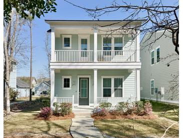 Charming two-story home with a double-porch, light blue siding, and landscaped front yard at 114 E Respite Ln, Summerville, SC 29483
