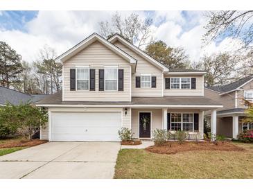 Charming two-story home with attached garage, black shutters, and welcoming front porch at 122 Moon Shadow Ln, Summerville, SC 29485