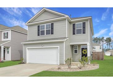 Charming two-story home with gray siding, attached garage, and landscaped front yard for appealing curb appeal at 131 Horizon Ridge Dr, Summerville, SC 29486
