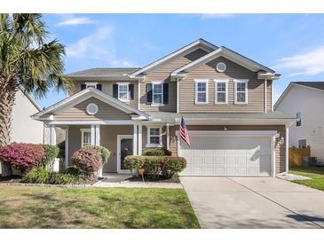 Charming two-story home boasts a two-car garage and well-manicured landscaping at 146 Education Blvd, Ladson, SC 29456