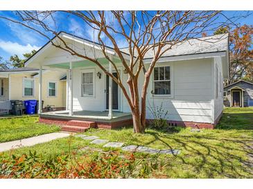 Charming single-story home with a brick foundation, a cozy front porch, and a well-maintained lawn at 2120 Thornlee Dr, North Charleston, SC 29405