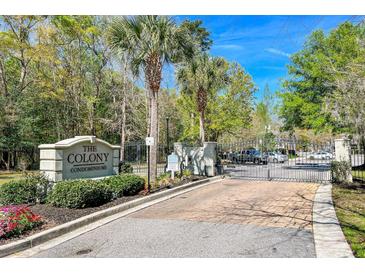 Gated entrance to The Colony Condominiums with a stone sign and well-maintained landscaping at 2434 Egret Crest Ln, Charleston, SC 29414