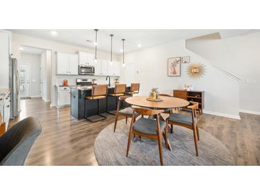 Modern kitchen featuring a large island, granite countertops, pendant lighting, and stainless steel appliances at 286 Godwit Dr, Summerville, SC 29486