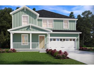 Charming two-story home showcasing a light green facade, covered front porch, and attached two-car garage at 321 Calm Water Way, Summerville, SC 29486