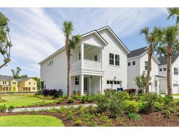 Charming two-story home with white siding, a cozy front porch, and well-manicured landscaping at 356 Claret Cup Way, Charleston, SC 29414