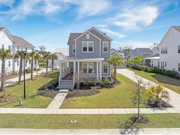 Charming two-story home with landscaped yard, inviting front porch, and beautiful curb appeal in a vibrant community at 3785 Summerton St, Mount Pleasant, SC 29466