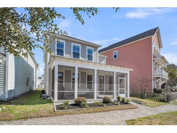 Charming two-story home featuring a spacious screened-in back porch with manicured landscaping at 4603 Scout Aly, North Charleston, SC 29405