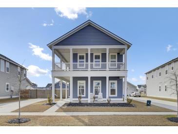 Charming two-story home with a double porch, blue siding, and nicely landscaped yard at 69 Arrowwood Way, Summerville, SC 29485