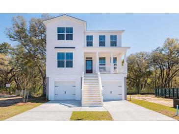 Charming two-story white home with a double garage and a welcoming front porch at 710 Minton Rd, James Island, SC 29412