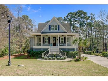Charming home featuring a welcoming front porch with a manicured lawn and mature trees at 1014 Bradbury Ln, Charleston, SC 29492