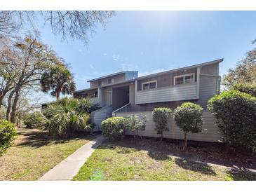 Charming condo exterior with a well-maintained lawn and landscaped greenery creating a welcoming ambiance at 1158 Village Creek Ln # 3, Mount Pleasant, SC 29464