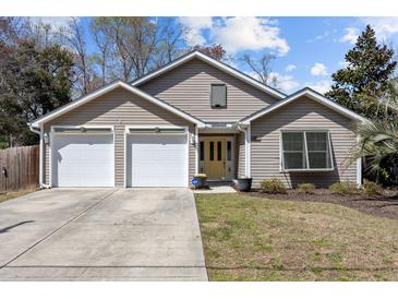 Charming single Gathering home with a yellow front door, two-car garage, and well-maintained lawn at 1617 Southwick Dr, Johns Island, SC 29455