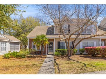 Charming brick and siding townhome featuring a landscaped front yard and inviting entrance at 205 Yellow Hawthorn Cir, Summerville, SC 29483