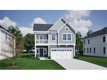 Charming two-story home featuring a balcony, attached garage, and a well-manicured front lawn at 223 O'Leary Circle Dr, Summerville, SC 29483
