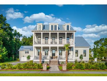 Stunning two-story home featuring double porches, landscaped yard, and a charming walkway leading to the front entrance at 3893 Summerton St, Mount Pleasant, SC 29466