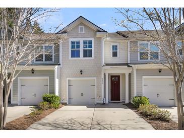 Charming townhome with a well-maintained lawn and attached garage, offering a welcoming curb appeal at 4852 Rocking Porch Ln, Summerville, SC 29485