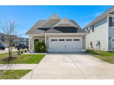 Charming single-Gathering home featuring a two-car garage and well-maintained landscaping at 546 Alderly Dr, Moncks Corner, SC 29461