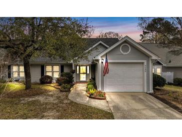 Charming single-story home featuring an attached garage, well-maintained lawn, and inviting curb appeal at 9080 Delancey Cir, North Charleston, SC 29406