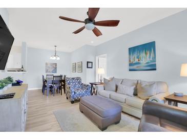 Comfortable living room with a ceiling fan, sofa, and artwork provides a relaxing space at 1600 Long Grove Dr # 626, Mount Pleasant, SC 29464