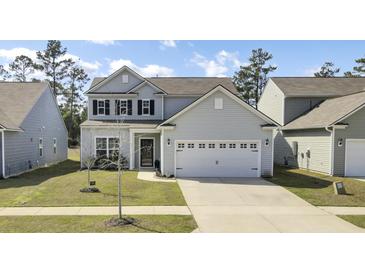 Charming two-story home with a well-manicured lawn, two-car garage, and welcoming curb appeal at 203 Hayworth Rd, Summerville, SC 29486