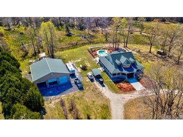 Sprawling property featuring a home with a pool, large garage, and several vehicles parked on the grounds at 212 Chester Ln, Cottageville, SC 29435