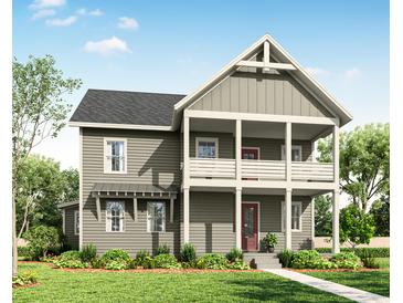 Charming two-story home featuring a covered front porch and a well-manicured lawn at 2950 Lodge Berry Ln, Johns Island, SC 29455