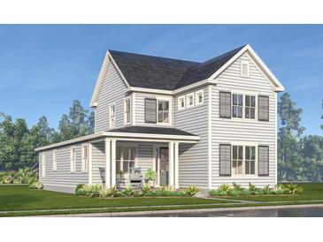 Charming two-story home featuring gray siding, dark shutters, and a welcoming front porch at 2964 Lodge Berry Ln, Johns Island, SC 29455