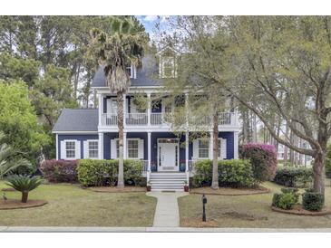 Charming two-story home with a double porch, lush landscaping, and a well-manicured lawn at 3409 Southern Cottage Way, Mount Pleasant, SC 29466