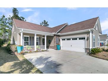 Charming home with a two-car garage, cozy front porch, beautiful stone accents, and well-manicured landscaping at 458 Four Seasons Blvd, Summerville, SC 29486