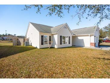 Well-maintained single-story home with white siding and a manicured front lawn on a sunny day at 5020 Holdsworth Dr, Summerville, SC 29485